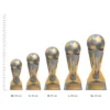Football Mercury trophies next to ruler